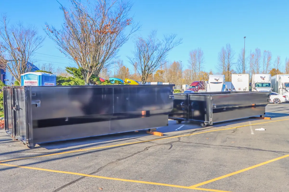 Professional dumpster rental service with roll-off container on residential driveway in Pine Castle